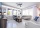 Bright living room featuring tile flooring, neutral furniture, and ample natural light through large windows at 1311 Arisha Dr, Kissimmee, FL 34746