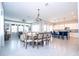 Open-concept living space with tile flooring, dining area, breakfast bar, and modern kitchen appliances at 1311 Arisha Dr, Kissimmee, FL 34746