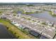 Aerial view of homes with backyard pools and lake views in a well-planned community at 13462 Panama Beach Ct, Orlando, FL 32827