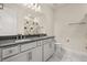 Bathroom featuring double sinks, modern lighting, vanity, and a large mirror at 13462 Panama Beach Ct, Orlando, FL 32827
