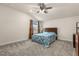 Cozy bedroom featuring carpet, a ceiling fan, and a window for natural light at 13462 Panama Beach Ct, Orlando, FL 32827