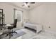 Bright bedroom with ceiling fan, neutral tones, a desk and a bright window view at 13462 Panama Beach Ct, Orlando, FL 32827