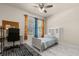 Cozy bedroom featuring neutral tones, a ceiling fan, and a bright window view at 13462 Panama Beach Ct, Orlando, FL 32827