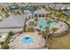 Aerial view of the community pool, splashpad, clubhouse, and tennis courts at 13462 Panama Beach Ct, Orlando, FL 32827