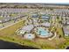 Aerial view of the community pool, splashpad, clubhouse, and tennis courts at 13462 Panama Beach Ct, Orlando, FL 32827