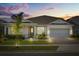 Charming single-Gathering home with well-manicured lawn and inviting front entrance at dusk at 13462 Panama Beach Ct, Orlando, FL 32827