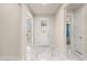 Bright foyer with elegant marble floors and decorative glass front door at 13462 Panama Beach Ct, Orlando, FL 32827