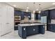 Gourmet kitchen boasts stylish navy blue cabinets and stainless steel appliances at 13462 Panama Beach Ct, Orlando, FL 32827