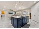 Gourmet kitchen boasts stylish navy blue cabinets and stainless steel appliances open to living room at 13462 Panama Beach Ct, Orlando, FL 32827