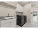 Well-lit laundry room featuring modern washer and dryer, granite countertop and storage at 13462 Panama Beach Ct, Orlando, FL 32827