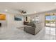 Spacious living room features modern tile flooring and a sliding glass door to the outdoor area at 13462 Panama Beach Ct, Orlando, FL 32827