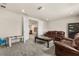 Living room features comfy couches, carpet floors, a dark wood coffee table and a projector at 13462 Panama Beach Ct, Orlando, FL 32827