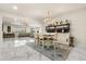 Open-concept living and dining area with marble floors, chandelier, and lots of light at 13462 Panama Beach Ct, Orlando, FL 32827
