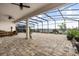Expansive screened patio with brick flooring, ceiling fans, and outdoor furniture with lake views at 13462 Panama Beach Ct, Orlando, FL 32827