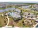 Aerial view of community pool and playground, featuring lush landscaping, spacious lounging areas, and lakeside views at 13462 Panama Beach Ct, Orlando, FL 32827