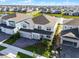 Aerial view of the home featuring a well-manicured lawn and proximity to a serene pond at 13758 Tybee Beach Ln, Orlando, FL 32827