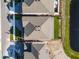 Aerial view showcases the rooftop, landscaped yard, and proximity to a pond at 13758 Tybee Beach Ln, Orlando, FL 32827