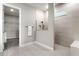 Modern bathroom featuring a glass-enclosed shower and a walk-in closet for convenient storage at 13758 Tybee Beach Ln, Orlando, FL 32827