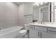 Modern bathroom featuring a tub and shower combo with tile surround and a white vanity at 13758 Tybee Beach Ln, Orlando, FL 32827