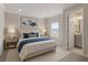 Inviting bedroom featuring a comfortable bed, soft lighting, and an en-suite bathroom at 13758 Tybee Beach Ln, Orlando, FL 32827