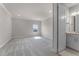Spacious bedroom with plush carpeting, soft lighting, and an en-suite bathroom at 13758 Tybee Beach Ln, Orlando, FL 32827