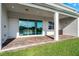 Covered patio with brick flooring and sliding glass doors providing scenic backyard views at 13758 Tybee Beach Ln, Orlando, FL 32827