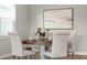 Close-up of dining table with seating for four in dining room with natural light at 13758 Tybee Beach Ln, Orlando, FL 32827