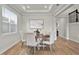 Formal dining room with decorative tray ceiling, light walls and wood floors at 13758 Tybee Beach Ln, Orlando, FL 32827