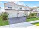 Attractive two-story home with a three-car garage, brick driveway, and well-kept front yard at 13758 Tybee Beach Ln, Orlando, FL 32827