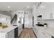 Bright kitchen with white cabinetry, quartz countertops, stainless appliances, and a breakfast bar at 13758 Tybee Beach Ln, Orlando, FL 32827