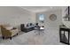 Relaxing living room featuring stylish seating, plush carpeting, and a modern decor at 13758 Tybee Beach Ln, Orlando, FL 32827