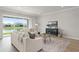 Relaxing living room with neutral decor, large sliding glass doors, and serene water views at 13758 Tybee Beach Ln, Orlando, FL 32827