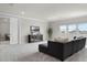 Bright living room with large windows, plush carpeting, and comfortable seating arrangement at 13758 Tybee Beach Ln, Orlando, FL 32827