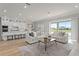 Bright, open-concept living space flows from the modern kitchen with a view of the serene backyard pond at 13758 Tybee Beach Ln, Orlando, FL 32827