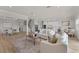 Open-concept living room with modern furnishings, hardwood floors, and staircase at 13758 Tybee Beach Ln, Orlando, FL 32827