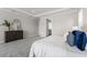 Spacious main bedroom with a dark wood dresser and ensuite bathroom with modern finishes at 13758 Tybee Beach Ln, Orlando, FL 32827