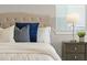 Elegant main bedroom featuring tufted headboard, plush pillows, and a nightstand at 13758 Tybee Beach Ln, Orlando, FL 32827