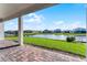 Brick paved patio overlooking a picturesque pond and neighboring houses on a sunny day at 13758 Tybee Beach Ln, Orlando, FL 32827