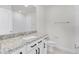 Bright bathroom with white cabinets, granite counters, and modern fixtures at 14538 Orchid Island Dr, Orlando, FL 32827