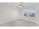 Well-lit bedroom with neutral carpet, ceiling fan, and bright windows at 14538 Orchid Island Dr, Orlando, FL 32827