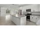 Bright, open kitchen featuring an island, stainless steel appliances, and granite countertops at 14538 Orchid Island Dr, Orlando, FL 32827