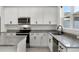 Beautiful kitchen with white cabinets, stainless steel appliances, and granite countertops at 14538 Orchid Island Dr, Orlando, FL 32827