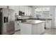 Stylish kitchen with white cabinets, stainless steel appliances, and a central island at 14538 Orchid Island Dr, Orlando, FL 32827