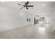 Bright open-concept living room with neutral tile flooring and modern ceiling fan at 14538 Orchid Island Dr, Orlando, FL 32827