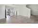 Spacious living area showcasing tile floors, staircase and a glimpse into the kitchen at 14538 Orchid Island Dr, Orlando, FL 32827