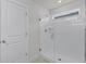 Bright white tiled shower with glass door at 14538 Orchid Island Dr, Orlando, FL 32827