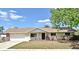 Charming single-story home with a well-maintained lawn and an attached two-car garage at 1515 Pelican St, Longwood, FL 32750