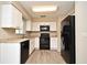 Updated kitchen with white cabinets, black appliances, and light countertops at 1515 Pelican St, Longwood, FL 32750