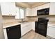 Modern kitchen with white cabinets and stainless steel appliances at 1515 Pelican St, Longwood, FL 32750