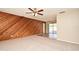 Open-concept living area with wood accent wall and view to the outdoors at 1515 Pelican St, Longwood, FL 32750